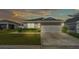 Charming single-Gathering home featuring a well-manicured lawn, a two-car garage, and complemented by lush landscaping at 3946 Willow Ridge Dr, Lakeland, FL 33810