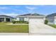 Charming single-Gathering home featuring a well-manicured lawn, a two-car garage, and complemented by lush landscaping at 3946 Willow Ridge Dr, Lakeland, FL 33810