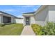 Inviting front entrance with a decorative wreath, a well-maintained lawn, and lush landscaping at 3946 Willow Ridge Dr, Lakeland, FL 33810
