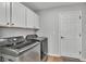 Well-organized laundry room with modern washer, dryer, and overhead cabinets at 3946 Willow Ridge Dr, Lakeland, FL 33810