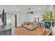 Spacious living room with hardwood floors, a modern ceiling fan, and sliding glass doors to the patio at 3946 Willow Ridge Dr, Lakeland, FL 33810