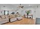 Bright and open living room featuring hardwood floors, a modern ceiling fan, and stylish decor at 3946 Willow Ridge Dr, Lakeland, FL 33810