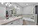 A stylish main bathroom features double sinks, a soaking tub, and a glass-enclosed shower at 3946 Willow Ridge Dr, Lakeland, FL 33810