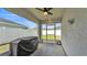 Covered patio features a ceiling fan, lighting, and a screened enclosure leading to the fenced backyard at 3946 Willow Ridge Dr, Lakeland, FL 33810