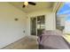 Covered outdoor patio space with access to the backyard through sliding glass doors and a ceiling fan at 3946 Willow Ridge Dr, Lakeland, FL 33810