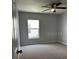Bedroom featuring carpet, a ceiling fan, and a window to the exterior at 4038 Oak Loop # 103, Mulberry, FL 33860
