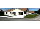 Newer exterior featuring individual driveways and modern design elements under a blue sky at 4038 Oak Loop # 103, Mulberry, FL 33860