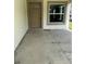 Concrete front porch showing the front door and window of the unit at 4038 Oak Loop # 103, Mulberry, FL 33860