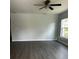Living room featuring hard surface floors, a ceiling fan, and a window to the exterior at 4038 Oak Loop # 103, Mulberry, FL 33860