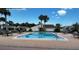 A serene pool surrounded by lounge seating offers a perfect outdoor community gathering spot at 4038 Oak Loop # 103, Mulberry, FL 33860