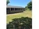 Large backyard with a screened in porch at the back of the home at 4127 Grove Pl, Lakeland, FL 33810