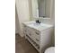 Bathroom featuring a white vanity with storage, modern fixtures, and bright neutral walls at 4127 Grove Pl, Lakeland, FL 33810