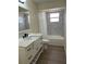 Updated bathroom featuring a marble-tiled shower/tub and a modern vanity with elegant fixtures at 4127 Grove Pl, Lakeland, FL 33810