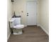 Bathroom with white fixtures, wood-look flooring, and a modern design at 4127 Grove Pl, Lakeland, FL 33810