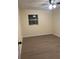 Bedroom features wood-look flooring, neutral paint, and a window offering natural light at 4127 Grove Pl, Lakeland, FL 33810