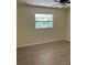 Simple bedroom with a ceiling fan and view outside at 4127 Grove Pl, Lakeland, FL 33810