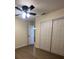 Bedroom with a ceiling fan and closet with sliding doors at 4127 Grove Pl, Lakeland, FL 33810