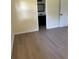 Bright bedroom with wood-look flooring and neutral paint, leading to the bathroom at 4127 Grove Pl, Lakeland, FL 33810