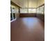 Well-lit enclosed porch featuring tiled flooring, windows, and serene views, ideal for relaxing or entertaining at 4127 Grove Pl, Lakeland, FL 33810