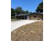 Charming single-story home featuring a covered front porch and long driveway at 4127 Grove Pl, Lakeland, FL 33810