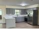 Stylish kitchen boasts gray cabinets, stainless steel appliances, and sleek countertops for modern living at 4127 Grove Pl, Lakeland, FL 33810