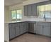 Modern kitchen design featuring gray cabinets, stainless steel appliances and a white countertop at 4127 Grove Pl, Lakeland, FL 33810