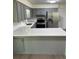Beautiful kitchen featuring gray cabinets, stainless steel appliances, and quartz countertops at 4127 Grove Pl, Lakeland, FL 33810