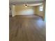 Spacious living room features new flooring, neutral walls, and plenty of natural light from the window at 4127 Grove Pl, Lakeland, FL 33810