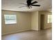 Spacious living room features new flooring, neutral walls, and plenty of natural light from the window at 4127 Grove Pl, Lakeland, FL 33810