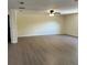 Spacious living room features new flooring, neutral walls, and plenty of natural light from the window at 4127 Grove Pl, Lakeland, FL 33810