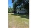 A metal outbuilding with a covered carport offers versatility for storage and projects at 4127 Grove Pl, Lakeland, FL 33810