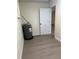 Utility room featuring a water heater, wood-look flooring, and ample space at 4127 Grove Pl, Lakeland, FL 33810