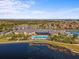 Aerial view of a community clubhouse, pool, and lake, showcasing a vibrant and amenity-rich residential area at 4193 Stone Creek Loop, Lake Wales, FL 33859