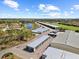 Overhead shot of storage units near a lake with trees and other neighborhood homes with clear blue skies above at 4193 Stone Creek Loop, Lake Wales, FL 33859