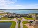 Stunning aerial view of a lakeside community clubhouse featuring lush landscaping, water views, and resort-style amenities at 4193 Stone Creek Loop, Lake Wales, FL 33859