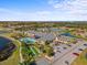 A bird's-eye view showcasing a community clubhouse, swimming pool, putting green, and a lush, walkable landscape at 4193 Stone Creek Loop, Lake Wales, FL 33859