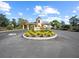 Inviting entrance to Lake Ashton with manicured landscaping and decorative signage at 4193 Stone Creek Loop, Lake Wales, FL 33859