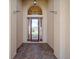 Inviting covered entry with decorative glass door and brick paver flooring at 4193 Stone Creek Loop, Lake Wales, FL 33859