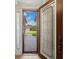 View through glass front door to brick paver walkway and neighborhood beyond at 4193 Stone Creek Loop, Lake Wales, FL 33859