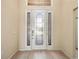 Elegant front door with decorative glass and sidelights at 4193 Stone Creek Loop, Lake Wales, FL 33859