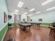 Spacious game room with billiard tables, laminate floors, and a comfortable setting at 4193 Stone Creek Loop, Lake Wales, FL 33859
