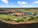 Aerial view of a neighborhood clubhouse with scenic golf course, water features, and blue skies at 4193 Stone Creek Loop, Lake Wales, FL 33859