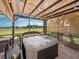 This covered hot tub has a great view of the green space behind the home, perfect for relaxing at 4193 Stone Creek Loop, Lake Wales, FL 33859
