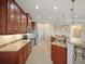 Bright kitchen with stainless steel appliances, granite countertops and warm wood cabinetry at 4193 Stone Creek Loop, Lake Wales, FL 33859