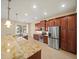 Modern kitchen with granite countertops, stainless steel appliances and custom cabinets at 4193 Stone Creek Loop, Lake Wales, FL 33859