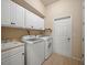 Bright laundry room with white cabinets and a utility sink at 4193 Stone Creek Loop, Lake Wales, FL 33859