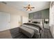Comfortable bedroom with natural light, a stylish accent wall and an ensuite bathroom at 4193 Stone Creek Loop, Lake Wales, FL 33859