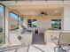 This outdoor kitchen features a built-in grill, mini-fridge, bar seating, and lovely tile backsplash at 4193 Stone Creek Loop, Lake Wales, FL 33859