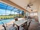 This outdoor living space offers a built-in kitchen, multiple seating areas, and a pool with a view at 4193 Stone Creek Loop, Lake Wales, FL 33859