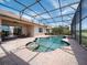 This lovely pool with screened-in enclosure has space for dining, relaxing, and enjoying the outdoors at 4193 Stone Creek Loop, Lake Wales, FL 33859